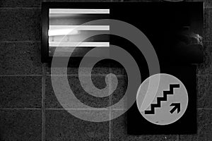 Stairs going up sign on wall background texture copy space.