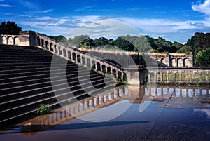 Stairs and historical ancient wall from the Victorian style reflected in the water