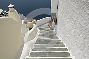 Stairs leading down to Aegan Sea. Oia, Santorini, Greece.