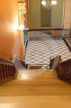 Stairs leading down to tiles diamond pattern floor in French Renaisance style.