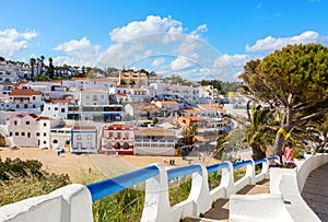 Stairs leading to the sandy beach surrounded by typical white houses, Carvoeiro, Algarve, Portugal