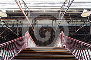 Stairs leading up under an old truss roof