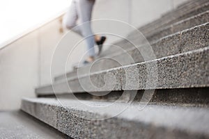 Stairs, legs and city person leaving, walking or on urban journey, urban commute or trip to destination. Outdoor blur