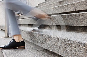 Stairs, legs and outdoor person walking, leave or on urban journey, business commute or trip to destination. Motion blur