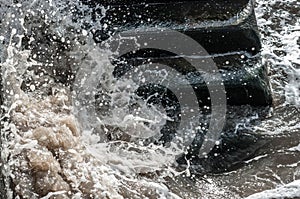 Black stone stairs in water on a showery day photo