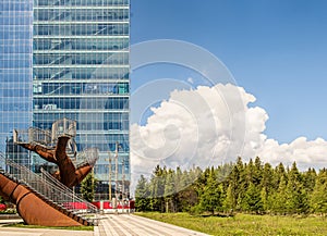 Stairs modern building and a forest beside with a cloudy blue sky