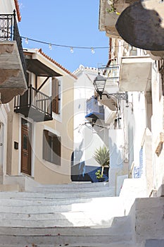 Stairs in the narrow street of Neorio town on Poros island, Greece; summer background