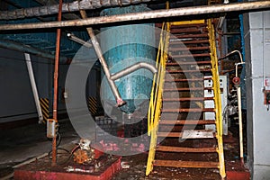 Stairs with steps and shelves with railings and equipment tanks at the industrial refinery chemical petrochemical