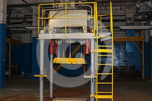 Stairs with steps and shelves with railings and equipment tanks at the industrial refinery chemical petrochemical