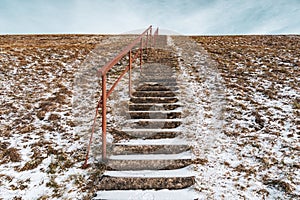Stairs stretching up to a snowy hill