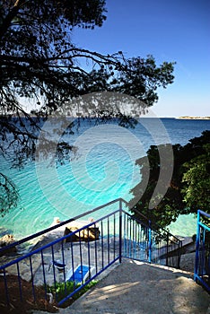 Stairs to the beach, clear water and blue sky in Croatia Dalmatia