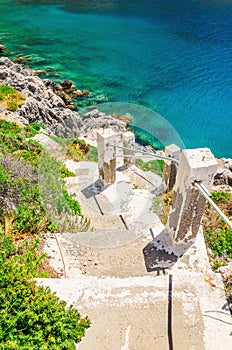 Stairs to the beach with green bushes, Greece