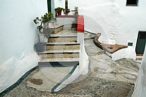 Stairs to entry door in a narrow alley