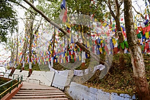 Stairs to Mahakal temple along colorful buddhism glags