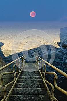 Stairs to ocean and to sky with Moon