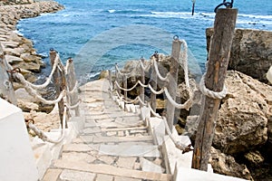 Stairs to the sea in rocky outcrops coast. Mahdia. Tunisia photo