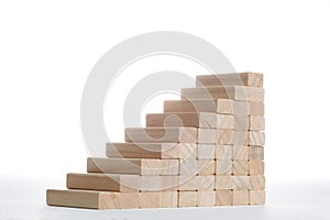 Stairs to success build with wooden blocks on grey background with copy space