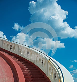 Stairs towards blue sky with clouds