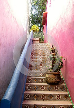 Stairs between two pink building walls. Sayulita village, Nayarit state, Mexico