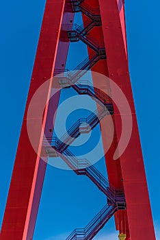 Stairs up the side of a giant red gantry crane..