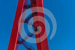 Stairs up the side of a giant red gantry crane..