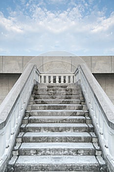 Stairs of white stonemason bridge against the blue cloudy sky