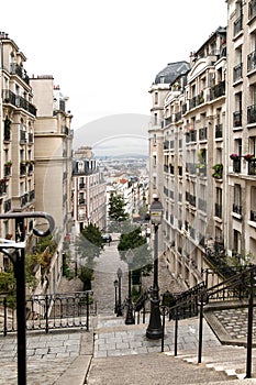 A stairway and city landscape through the historical buildings in Monmarte photo