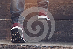 Stairway. Close up legs jeans and shoes sneakers red of young hipster man