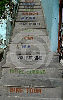 A stairway in Dharamsala depicting many travel options