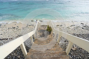 A stairway leading to a beach on a tropical Pacific island