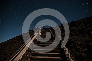 Stairway leading up to the night sky