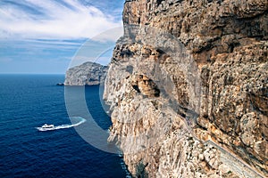 Stairway in limestone rock to stalactite Neptune cave. Boat leaving Grotte di Nettuno in Sardinia, Italy