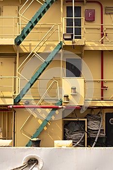 Stairway  with railing on aft side of the old big yellow metal ship