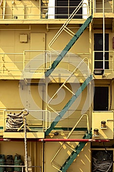 stairway with railing on aft side of the old big yellow metal ship in vertical frame