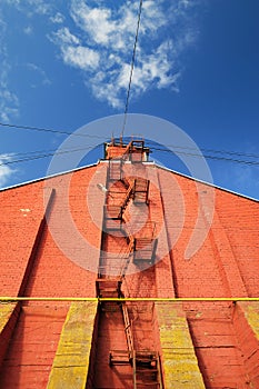 Stairway on red brick wall on clear blue sky