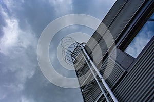 Stairway to Heaven. Metal staircase on the building against the background of the sky and clouds