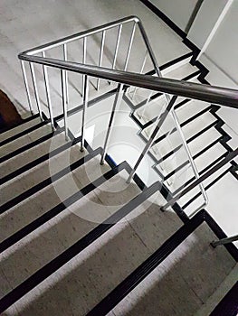 Stairwell fire escape in a modern building background.