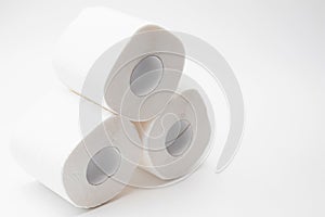 Stak rolls of toilet paper on white. Personal hygiene products