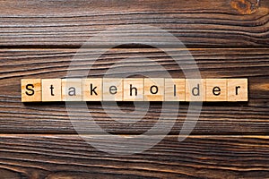 Stakeholder word written on wood block. Stakeholder text on wooden table for your desing, concept