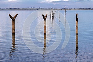 Stakes on the roof of the old railway station that was flooded by the dam of a Hydroelectric Plan