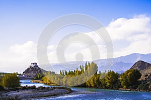 Stakna Gompa and Indus river before sunset with cloudy sky and mountains