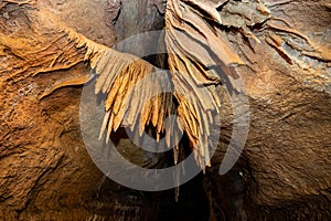 Stalactite and stalagmite and other formations inside a beautiful cave.