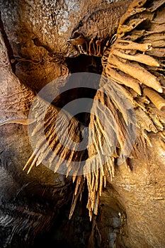 Stalactite and stalagmite and other formations inside a beautiful cave.