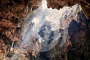 Stalagmite ,stalactite, limestone and tunnel with beam sunlight at Khao Luang cave.