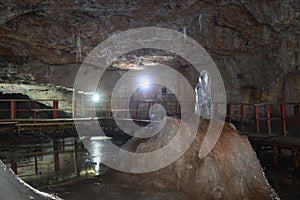 Stalagmite towards the Curch in the Great Hall of the Scarisoara cave, Romania.