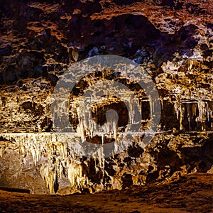 Stalagtite cave with multiple colors and holes in the rock