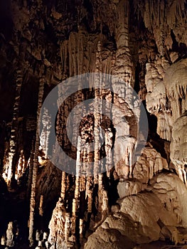 Stalagtites stalagmites and columns in underground cavern photo