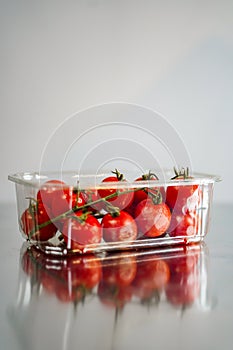 Stale tomatoes in a plastic box.