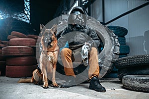 Stalker in gas mask and dog, post-apocalypse