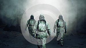 Stalkers in military protective clothing and a gas mask are walking along an abandoned and deserted metro. The concept photo